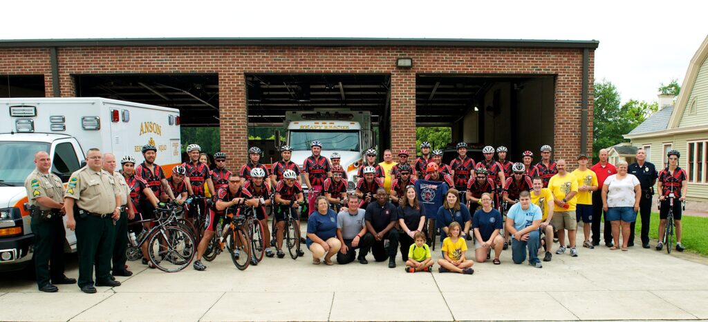 The riders in front of the fire department.